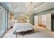 Spacious main bedroom with a tray ceiling, chandelier, french doors and sitting area at 4584 E Conway Nw Dr, Atlanta, GA 30327