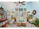 Bright sun room with floor-to-ceiling windows, cozy seating, zebra rug, and vaulted ceiling at 4584 E Conway Nw Dr, Atlanta, GA 30327