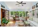 Bright sun room with floor-to-ceiling windows, cozy seating, and a decorative birdcage creating a serene retreat at 4584 E Conway Nw Dr, Atlanta, GA 30327