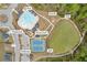Aerial view of community amenities including a pool, tennis court, fire pit, playground, pond, and trail at 509 Azalea Bloom Dr, Loganville, GA 30052