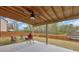Covered backyard patio with wood ceiling, fan, and outdoor entertainment space at 509 Azalea Bloom Dr, Loganville, GA 30052