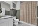 A full bathroom includes a shower with curtain, sink, and toilet at 509 Azalea Bloom Dr, Loganville, GA 30052