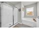 Bathroom featuring tile floors, glass shower, and a large tub at 509 Azalea Bloom Dr, Loganville, GA 30052