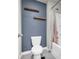 Bathroom featuring a white toilet, shower with light pink shower curtain, and stylish decor at 509 Azalea Bloom Dr, Loganville, GA 30052