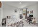 A cozy bedroom features a bed, desk, and a window for natural light at 509 Azalea Bloom Dr, Loganville, GA 30052