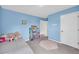 Cozy bedroom with a blue accent wall, featuring decor, storage, and carpeted flooring at 509 Azalea Bloom Dr, Loganville, GA 30052