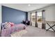 Cozy bedroom featuring a desk, carpeted floor, and a purple accent wall for a modern touch at 509 Azalea Bloom Dr, Loganville, GA 30052