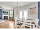 An elegant dining room is adjacent to the living room and features lots of natural light at 509 Azalea Bloom Dr, Loganville, GA 30052