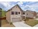 Attractive two-story home showcasing a brick exterior, attached garage, and well-maintained lawn at 509 Azalea Bloom Dr, Loganville, GA 30052