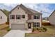 Charming two-story home with brick facade, well-manicured lawn, and attached two-car garage at 509 Azalea Bloom Dr, Loganville, GA 30052