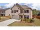 Beautiful two-story home featuring a brick facade, attached two-car garage, and lovely landscaping at 509 Azalea Bloom Dr, Loganville, GA 30052