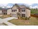 Stunning two-story home with brick and vinyl siding, attached two-car garage, and landscaped front yard at 509 Azalea Bloom Dr, Loganville, GA 30052