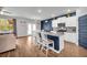 Open-concept kitchen with granite countertops, stainless steel appliances, and eat-in island with seating at 509 Azalea Bloom Dr, Loganville, GA 30052