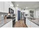 The kitchen offers white cabinets, a granite island, and stainless steel appliances at 509 Azalea Bloom Dr, Loganville, GA 30052