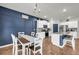 An open-concept room includes a dining room and living area with modern decor at 509 Azalea Bloom Dr, Loganville, GA 30052