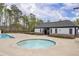 Community pool area featuring a hot tub and an adjacent pool house with bathrooms for residents' convenience at 509 Azalea Bloom Dr, Loganville, GA 30052