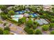 Overhead shot of a community with pool, tennis courts, clubhouse, and well-manicured green spaces at 6020 Ettington Dr, Suwanee, GA 30024