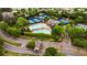 Aerial view of a community showcasing pool, tennis courts, clubhouse, and mature landscaping at 6020 Ettington Dr, Suwanee, GA 30024