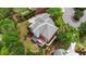 Aerial view of a grand brick home with lush greenery, a spacious yard, and a private setting at 6020 Ettington Dr, Suwanee, GA 30024