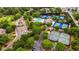 Aerial view of a community featuring a pool, tennis courts, and tree-lined streets at 6020 Ettington Dr, Suwanee, GA 30024