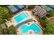 Stunning aerial view of community amenities including pools, tennis courts, and community lodge at 6020 Ettington Dr, Suwanee, GA 30024