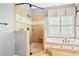 Bathroom showcasing a soaking tub with decorative tile and glass shower area at 6020 Ettington Dr, Suwanee, GA 30024