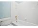 Full bathroom with white tile walls, a bathtub and a toilet at 6020 Ettington Dr, Suwanee, GA 30024