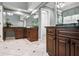 Large bathroom with custom wood cabinets, granite counters, and large mirrors at 6020 Ettington Dr, Suwanee, GA 30024