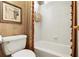 Well-lit bathroom featuring white tile, decorative shower curtains and tasteful decor at 6020 Ettington Dr, Suwanee, GA 30024
