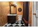 Cozy bathroom with black and white tile flooring, a vanity, and decorative accents at 6020 Ettington Dr, Suwanee, GA 30024