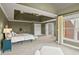 Bright main bedroom featuring a tray ceiling, a lounge and plush carpeting at 6020 Ettington Dr, Suwanee, GA 30024