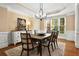 An elegant dining room is showcased with a modern chandelier, neutral walls, and a formal dining set at 6020 Ettington Dr, Suwanee, GA 30024