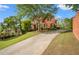 Lovely brick home with a long driveway, manicured lawn, and mature trees in a serene setting at 6020 Ettington Dr, Suwanee, GA 30024