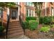 Inviting front entrance featuring brick steps, elegant door, and lush landscaping at 6020 Ettington Dr, Suwanee, GA 30024
