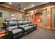 Luxurious home theater features leather reclining chairs and a cozy built-in nook at 6020 Ettington Dr, Suwanee, GA 30024