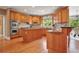 Spacious kitchen featuring wood cabinets, stainless steel appliances, a central island, and hardwood floors at 6020 Ettington Dr, Suwanee, GA 30024