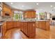 Well-appointed kitchen featuring a central island, wooden cabinetry, and modern appliances at 6020 Ettington Dr, Suwanee, GA 30024