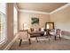 Cozy living room with neutral-toned walls, plush seating, and abundant natural light streaming through the large window at 6020 Ettington Dr, Suwanee, GA 30024
