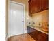 Inviting mudroom with custom built-ins, granite countertop and wood flooring at 6020 Ettington Dr, Suwanee, GA 30024