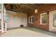 Covered patio area with brick siding, multiple windows, and an exterior door at 6020 Ettington Dr, Suwanee, GA 30024
