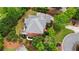 Brick home featuring a well-manicured lawn and a spacious outdoor deck surrounded by lush landscaping and mature trees at 6020 Ettington Dr, Suwanee, GA 30024