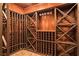 Custom wine cellar featuring wooden racks, ample storage, and space for wine glass display at 6020 Ettington Dr, Suwanee, GA 30024