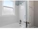 Well-lit bathroom features white subway tile, glass door knob, and window at 677 Somerset Ne Ter # C6, Atlanta, GA 30306