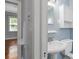 Charming bathroom features a pedestal sink and vanity with natural light from the bedroom at 677 Somerset Ne Ter # C6, Atlanta, GA 30306