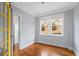 Comfortable bedroom featuring hardwood floors, trim details, and large windows for natural light at 677 Somerset Ne Ter # C6, Atlanta, GA 30306