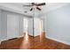 Spacious bedroom with hardwood floors, ceiling fan, and multiple doorways to other rooms at 677 Somerset Ne Ter # C6, Atlanta, GA 30306