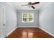 Empty bedroom featuring hardwood floors, neutral walls, and natural light from a window at 677 Somerset Ne Ter # C6, Atlanta, GA 30306