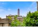 Exterior view with the building and the red tower against a blue sky with sparse clouds at 677 Somerset Ne Ter # C6, Atlanta, GA 30306