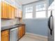 Modern kitchen with stainless steel appliances, light-colored tile floors, and blue-grey painted walls at 677 Somerset Ne Ter # C6, Atlanta, GA 30306