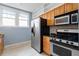 Efficient kitchen features stainless steel appliances, wooden cabinets, and ample counter space at 677 Somerset Ne Ter # C6, Atlanta, GA 30306